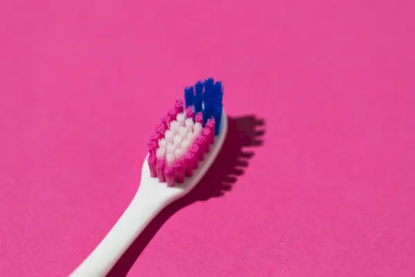 Young woman removing cream from her face during her skin care