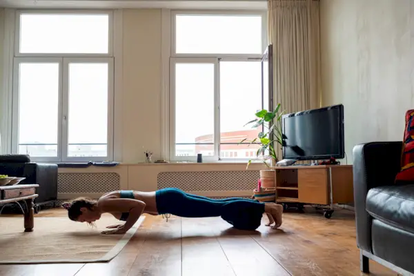 Female athlete skipping with jumping rope in gym