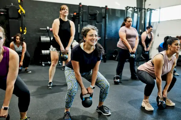 Exhausted athletic woman resting in a gym