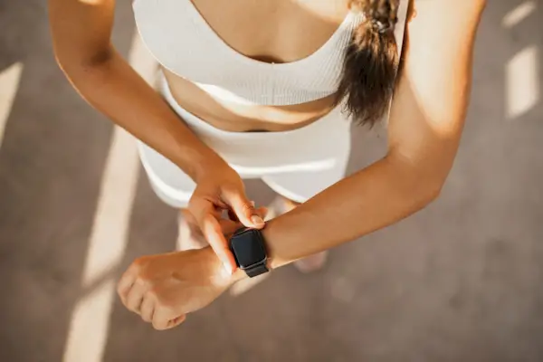 Woman start running app on smart watches. Gadgets in sport. Device screen. Healthy and active lifestyle