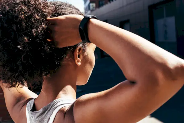 beautiful blonde woman doing sports practicing yoga against blue sky outdoors