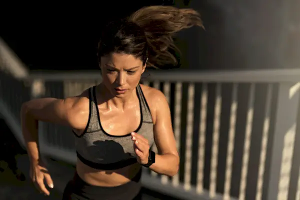 Athletic woman power walking outdoors in the morning.