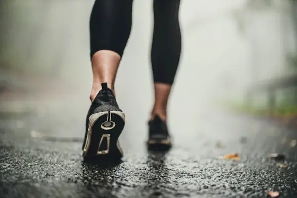 Close up of unrecognizable athlete walking during foggy day.