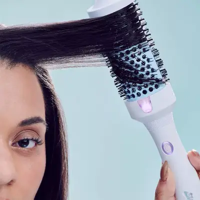 Woman using the Mane Its Giving Body Thermal Hot Brush