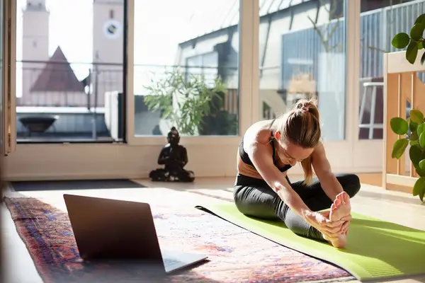 woman stretching on yoga mat