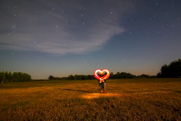 Couple Making Heart Shape With Wire Wools On Land At Night