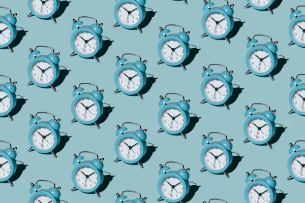 Pattern of alarm clocks on a blue background
