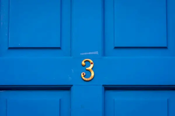 House Number 3 On A Blue Wooden Front Door