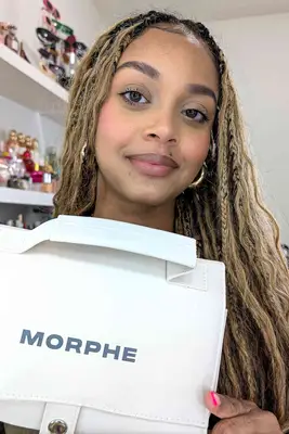 A person holding up a Morphe makeup brush holder