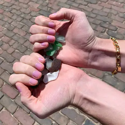 Short natural nails with glossy pink polish by Dior nail glow