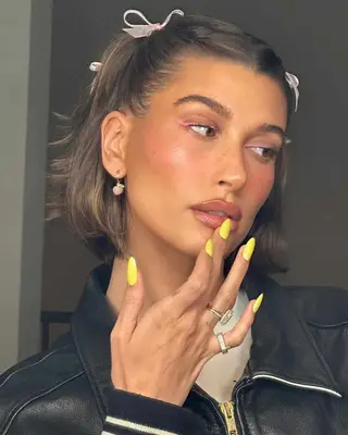 Hailey Bieber with neon yellow glazed nails