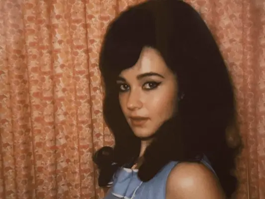 Kacey Musgraves wearing a large necklace and huge hair