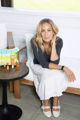 Sarah Jessica Parker posing next to her RoC skincare products