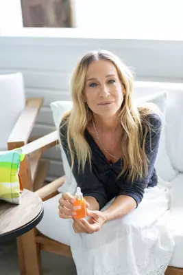 SJP holding her RoC Skincare collaboration vitamin C serum