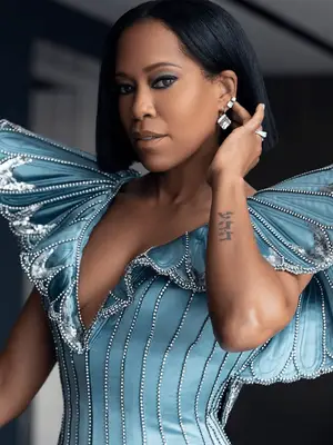 regina king wearing blunt bob with blue embellished dress