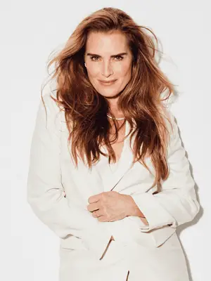 Brooke Shields posing in cream suit