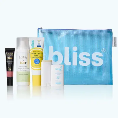 A blue bag with Bliss labeling and several skincare products infront of it