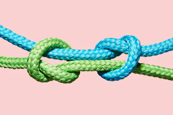 Two coloured ropes knotting together