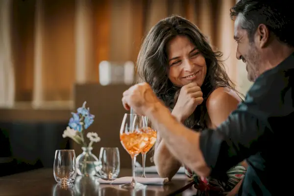 Happy mature couple enjoying drink in restaurant