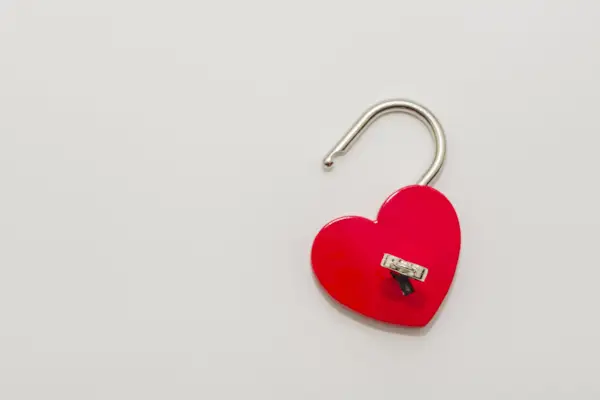 Heart shaped red lock with key.