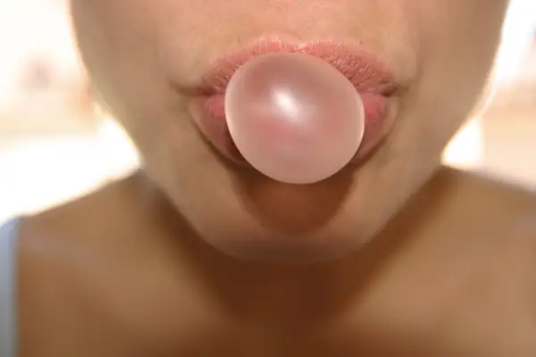 Woman doing chewing gum bubble