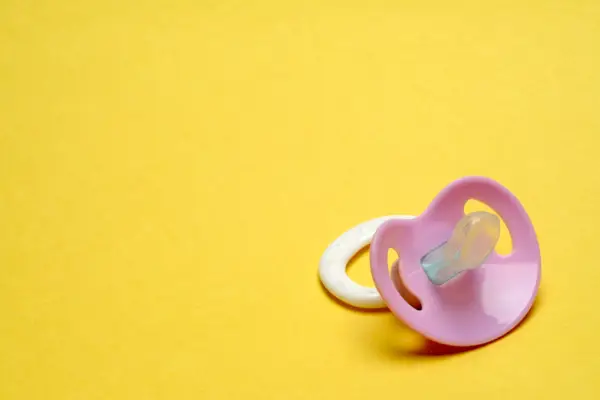 Dummy Pacifier on Yellow Background