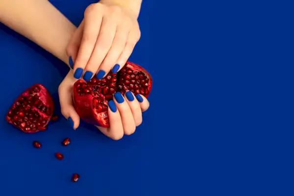 blue manicure with gold and lace background