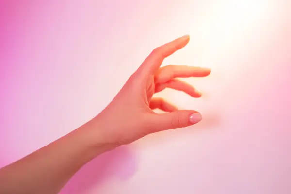 A beam of light illuminates the woman