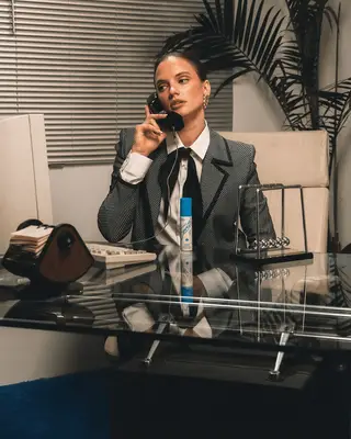 Woman in office with Vacation Super Spritz Mist