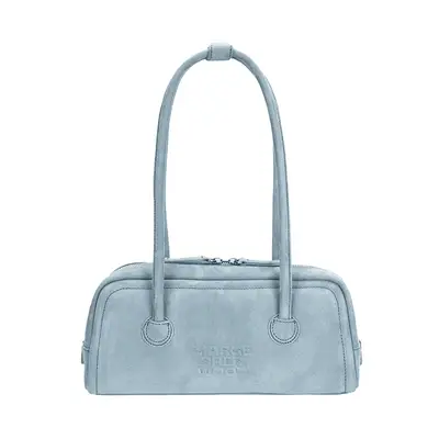 Bella Hadid wearing black long sleeve and holding tan suede fringe handbag