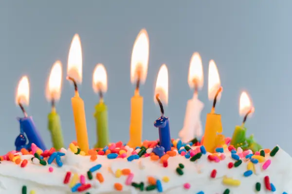 Lit birthday candles on cake