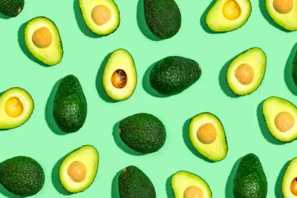 Fresh avocado pattern on a green background