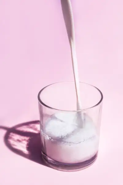 Close-Up Of Drink In Glass On Pink Table