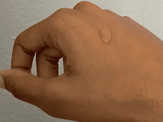 Texture shot on hand of naturium vitamin C serum