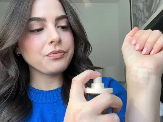Snif Me Fragrance being sprayed on the wrist