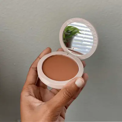 Hand holding Jones Road Bronzer Compact open