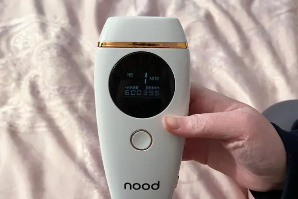 Closeup of hand holding nood The Flasher 2.0 digital screen