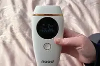 Closeup of hand holding nood The Flasher 2.0 digital screen