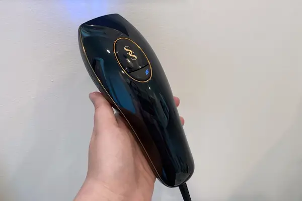 Hand holding SmoothSkin Pure IPL Hair Removal Device