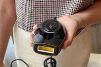 Closeup of hand holding SmoothSkin Pure Mini Intelligent Ultrafast IPL Permanent Hair Reduction