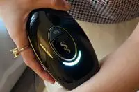 Closeup of hand holding SmoothSkin Pure Mini Intelligent Ultrafast IPL Permanent Hair Reduction to arm