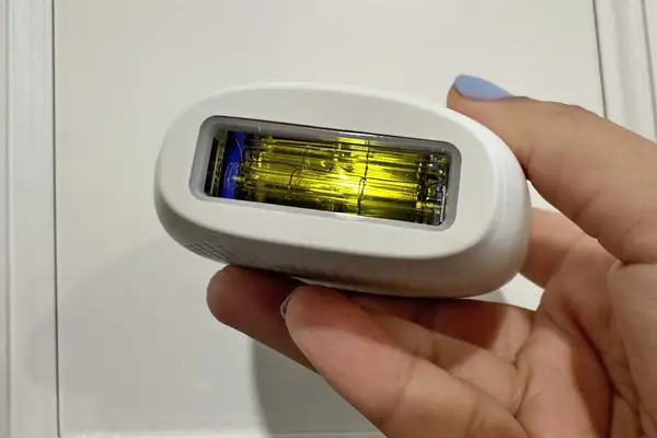 Closeup hand holding RoseSkinCo. Lumi IPL Hair Removal Handset