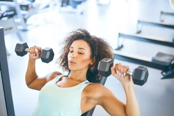 Young Woman Weightraining at the Gym