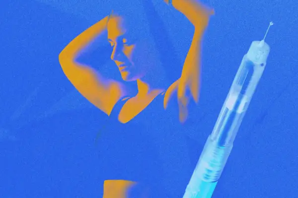 Mature woman working out with dumbbells during outdoor fitness class