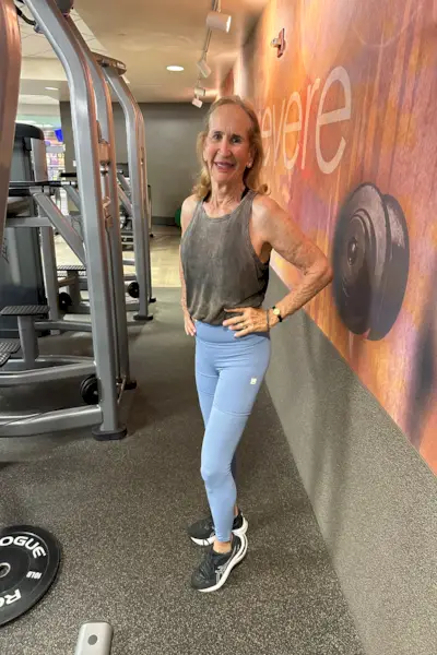 Protein isolate powder. Unflavored whey protein in measuring scoop and drinking glass in bright sunlight