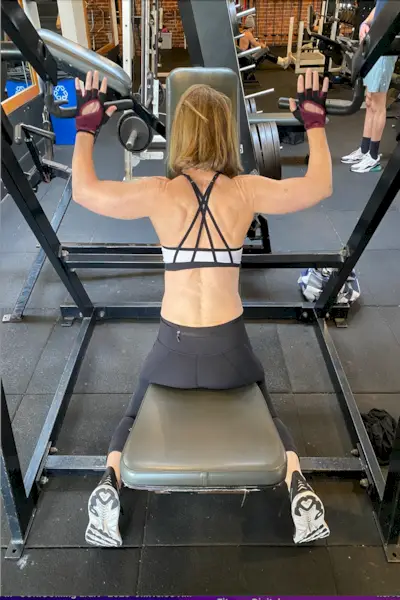 Female athlete skipping with jumping rope in gym