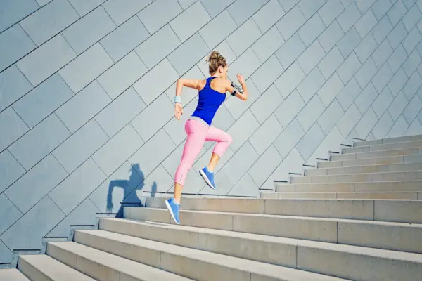 Young woman exercising with dumbbells at home