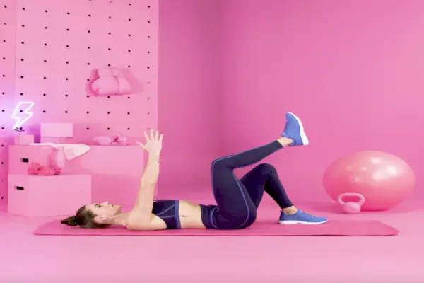 Shot of a young woman working out with weights in a gym