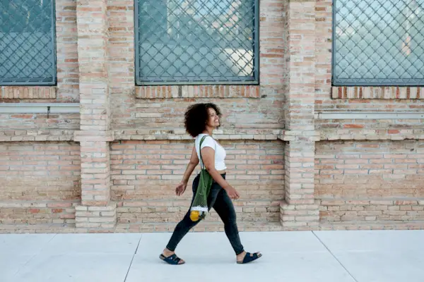 Happy woman walking in the street
