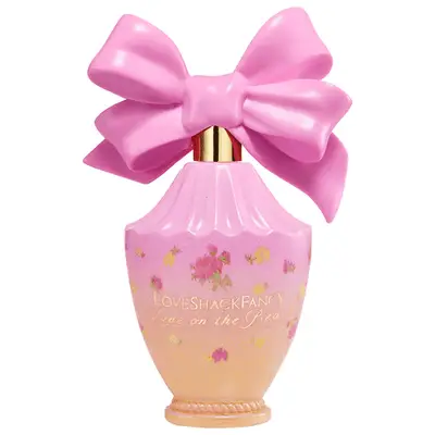 Bright pink and orange perfume bottle with large bow cap
